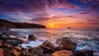 sunset over rocky coastline creates serene atmosphere and colorful sky at the ocean s edge in early evening