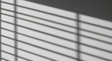 Abstract shadow patterns of window blinds on a white wall, minimal composition