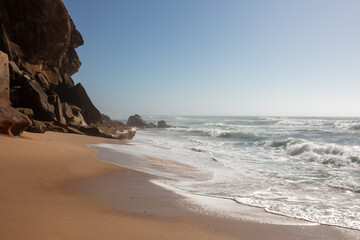 Dramatic Coastal Cliffs and Sandy Beach with Ocean Waves