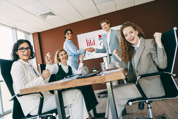 Fototapeta premium Business team celebrating success in a modern office during a collaborative meeting showcasing teamwork and professional growth