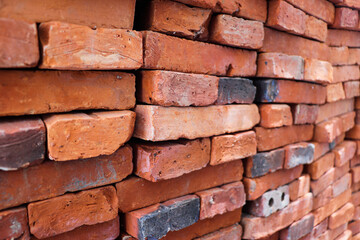Close-up of red bricks stacked, used for constructing house or wall