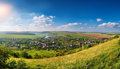 Naklejka premium picturesque landscape showcasing budaniv town from castle hill featuring colorful fields and lush greenery under a sunny sky in ternopil region ukraine