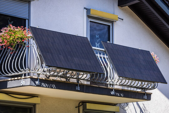 Balcony solar power plant. Solar battery on balcony wall. Mini PV plants generate your own electricity plug play