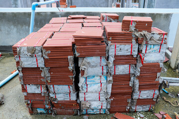 Red roof tiles packed and stacked, ready for rooftop installation