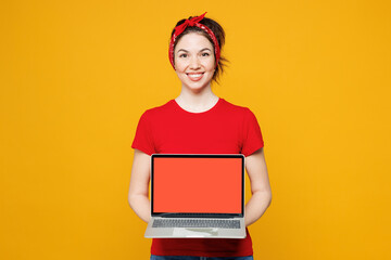 Young happy IT woman she wearing red t-shirt casual clothes hold use work on laptop pc computer...
