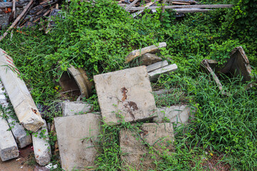 Used concrete formwork bases left on grassy area for disposal