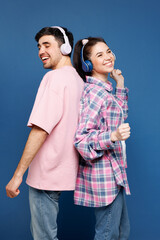 Young couple two friends family man woman wearing pink casual clothes together listen music in...