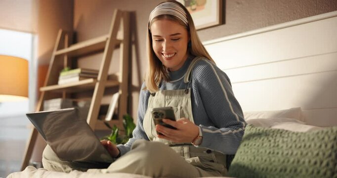 Happy, woman and message on smartphone, bedroom and ghostwriter with laptop for remote work or home. Online, freelancer and notification on mobile in house, texting and person with tech for ebook