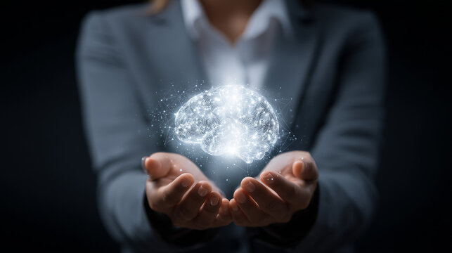Business professional holding a glowing digital brain, representing artificial intelligence and innovation in technology