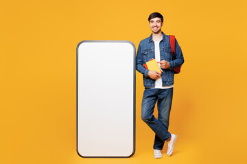 Full body young boy student wears denim casual clothes backpack bag point on big huge blank screen...