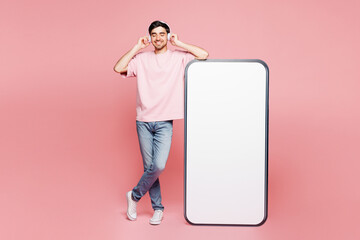 Full body young man wears t-shirt casual clothes big huge blank screen mobile cell phone smartphone...