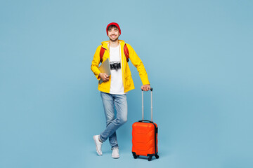 Traveler IT man wears yellow casual clothes work hold bag laptop pc computer isolated on plain blue...