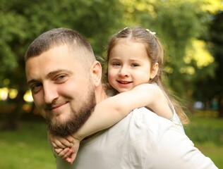 Fototapeta premium Happy Father's Day. Dad and his little daughter spending time together in park