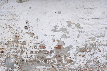 weathered brick wall with crumbling white plaster for background use