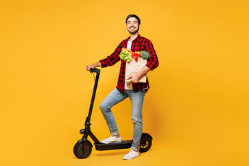 Full body side view young man wear casual clothes hold paper bag for takeaway mock up with food...