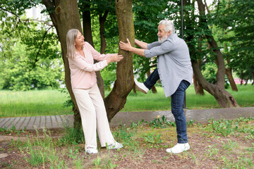 Lovely senior couple near tree in park