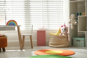 Stylish playroom with toys and furniture. Interior design