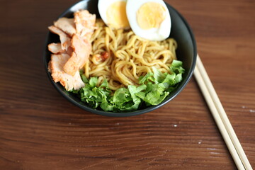 Japanese ramen with egg on black bowl in close-up