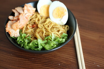 Japanese ramen with egg on black bowl in close-up