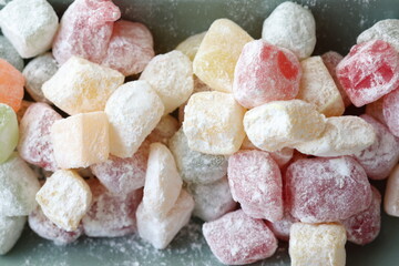 mini colors Turkish delights with roses on a white plate	