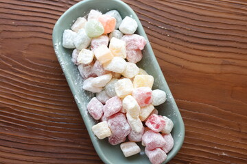 mini colors Turkish delights with roses on a white plate	