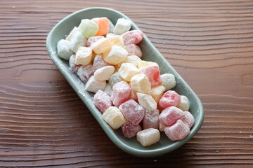 mini colors Turkish delights with roses on a white plate	