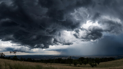 Fototapeta premium Powerful Storm System with Thick Clouds Rolling Over Wind-Swept Grass Dunes – Nature’s Dramatic Weather in Open Field Terrain Under Ominous Skies