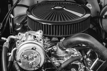 Classic sport car engine close up view with details photo in black and white.