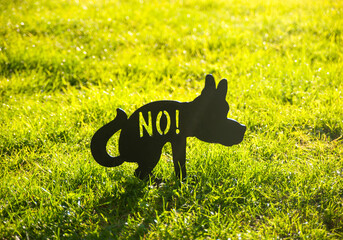 Prohibition sign for owners walking their dogs. Walking dogs is not allowed on the green lawns in...