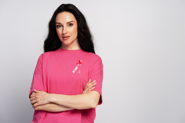 Confident woman wearing pink supporting breast cancer awareness