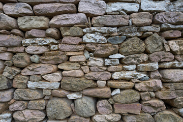 Stone wall. A wall made of large, colorful stones.