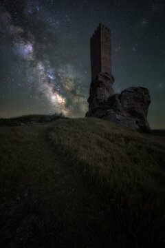 Ancient Zafra Castle in Spain, a medieval fortress silhouetted against a breathtaking Milky Way. Majestic night sky, stars and galaxy above historic ruins. Perfect for history, astronomy, travel