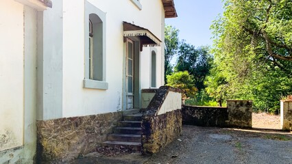 Charming rustic villa entrance, whispers of Enchanted Cottagecore, basking in midsummer solitude,...