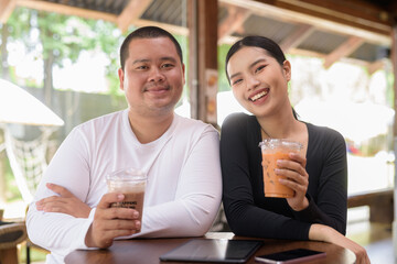 Happy young couple sitting in coffee shop