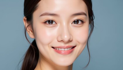 Smiling Young Woman with Smooth Skin Against Blue Background