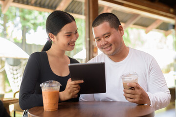 Happy young couple sitting in coffee shop