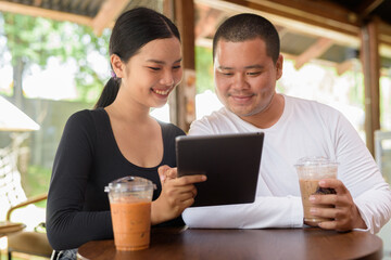 Happy young couple sitting in coffee shop