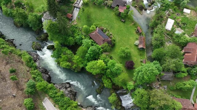 Watermill village Rastoke on rivers Slunj and Korana. Charming village of Rastoke with waterfalls, wooden houses, rivers running through. Aerial view of fairy-tale spring location in heart of Croatia