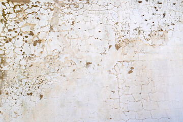 Cracked weathered outdoor whitewashed plaster wall - texture and background