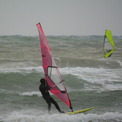 Water Sport Activity - Two Windsurfers on a Wavy Sea with Colorful Sails