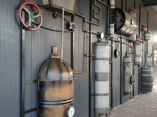 Vintage metal model of an old brewery on the wall