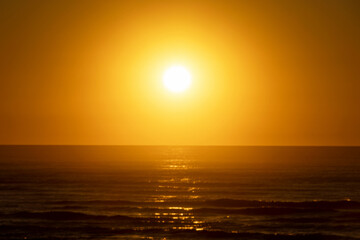 Sun that has just risen over the sea in a higher position with many blurred areas