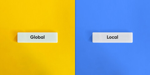 Global Versus Local Concept with Letter Tiles on Yellow and Blue Background