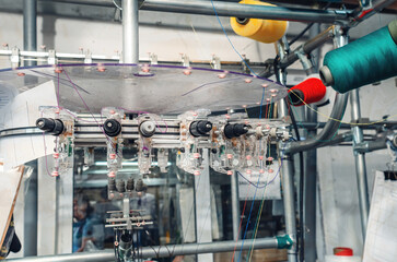 Thread tensioners located on spools on machines. Industrial enterprise for the production of socks....