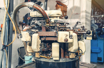 Knitting machine with cotton yarn in sock factory. Knitting machine with dust from yarn. Production...