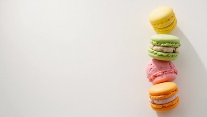 Colorful macarons stacked vertically on a white background with copy space