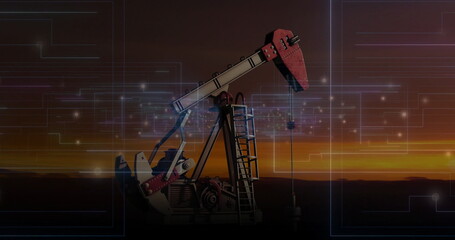 Operating red and grey oil pumpjack on remote plain at sunset, with digital circuit overlay