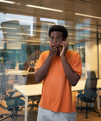 Shocked manager receiving bad news on phone in office