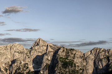 dramatic alpine mountain peaks under soft sunset light. powerful nature backdrop. minimalist mountain background with empty space for text or