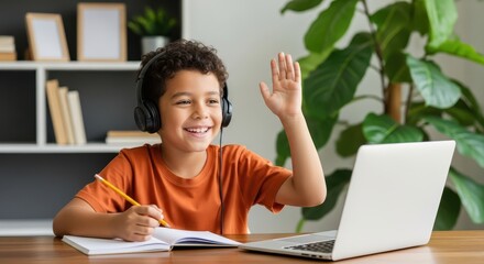 A happy young boy wearing headphones waves while participating in an online class on his laptop at home